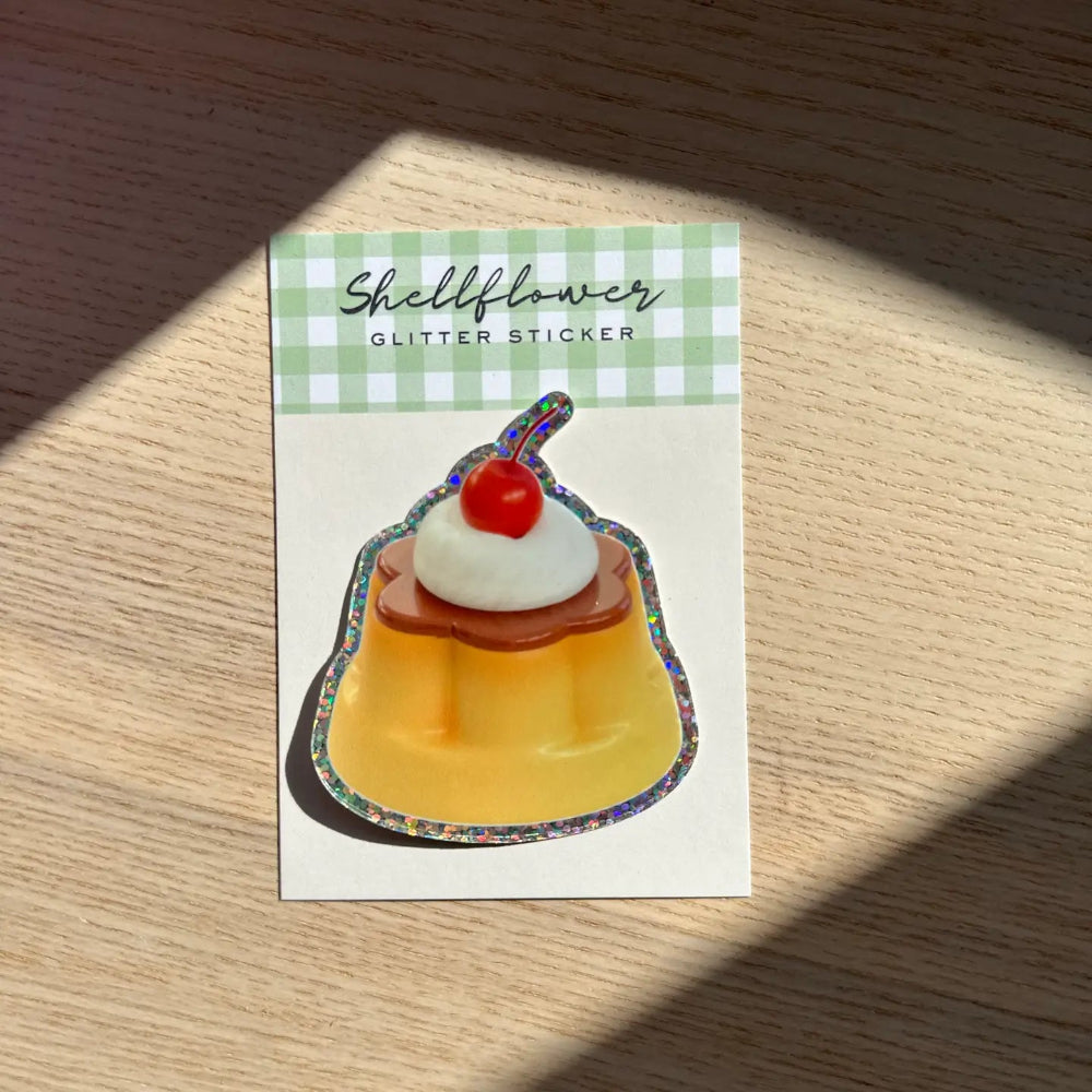 Custard sticker with glittery edge on a wooden background