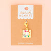 Colorful quilt charm on a 'Sarah Hearts' branded card with a pink background