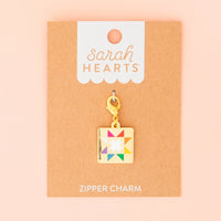 Colorful quilt charm on a 'Sarah Hearts' branded card with a pink background