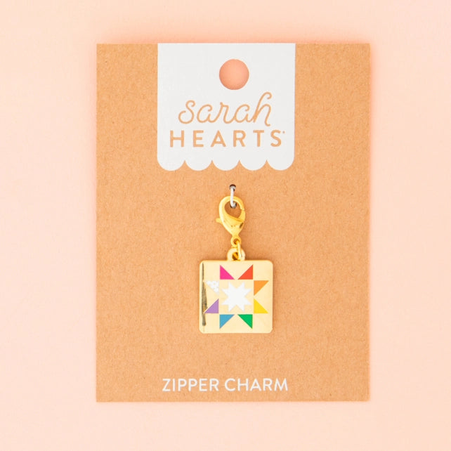 Colorful quilt charm on a 'Sarah Hearts' branded card with a pink background