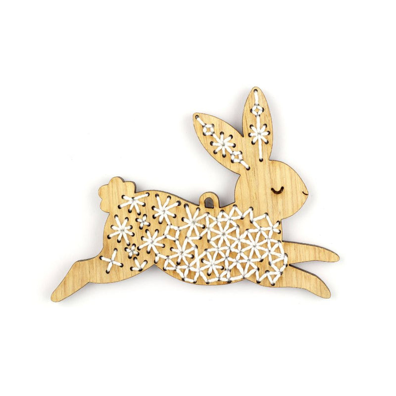 Wooden rabbit ornament with floral patterns on a white background