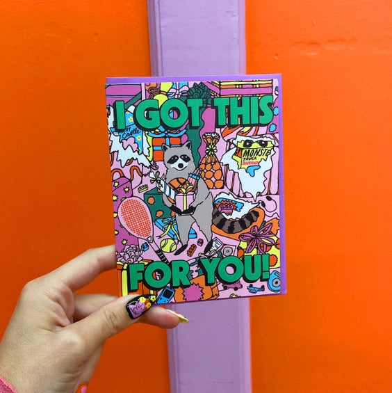 Raccoon holding present. 'I got this for you' in green bold letters