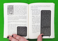 Open book held open by a hand on a green background