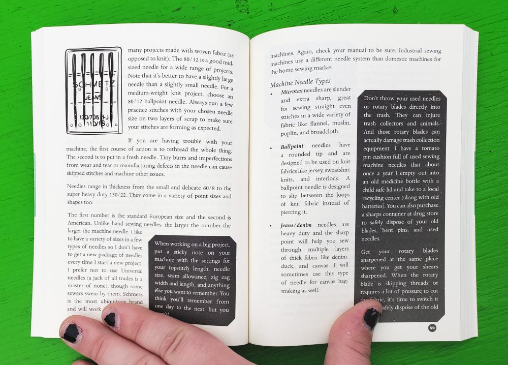 Open book held open by a hand on a green background