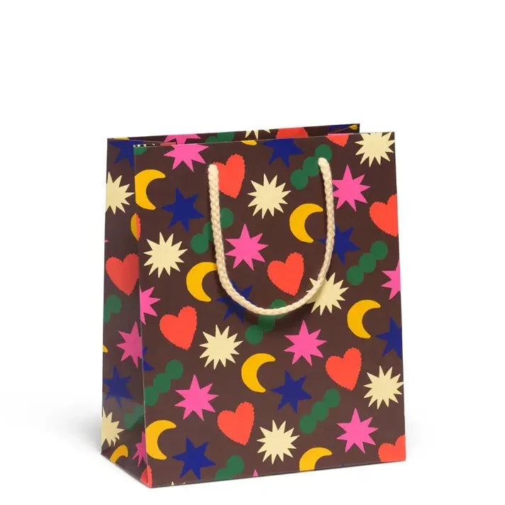 Gift bag with colorful rainbow charms on a dark background