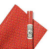 Red wrapping paper with colorful pattern and a roll of paper on a white background
