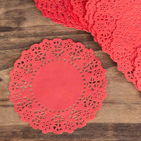 Red paper doilies on a wooden surface