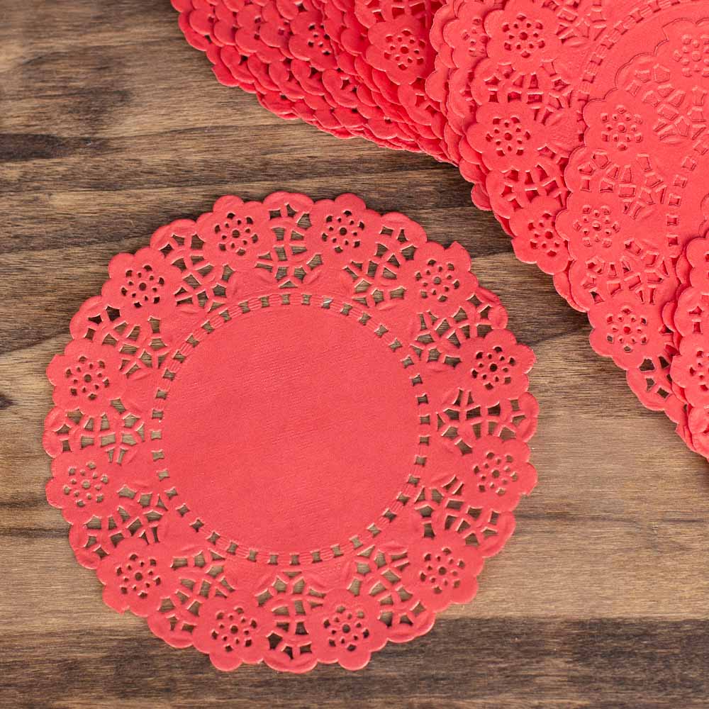 Red paper doilies on a wooden surface
