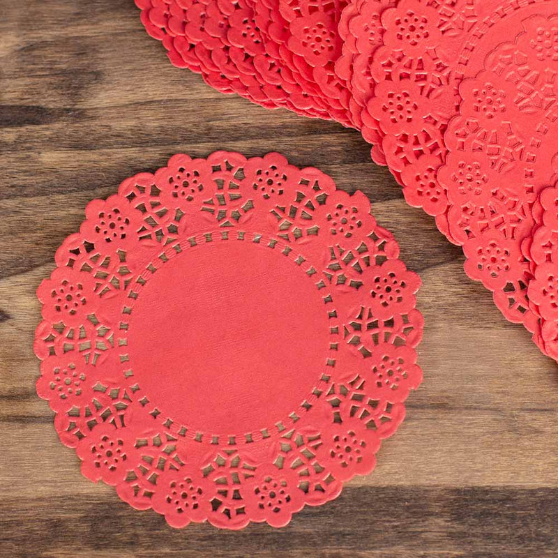 Red paper doilies on a wooden surface