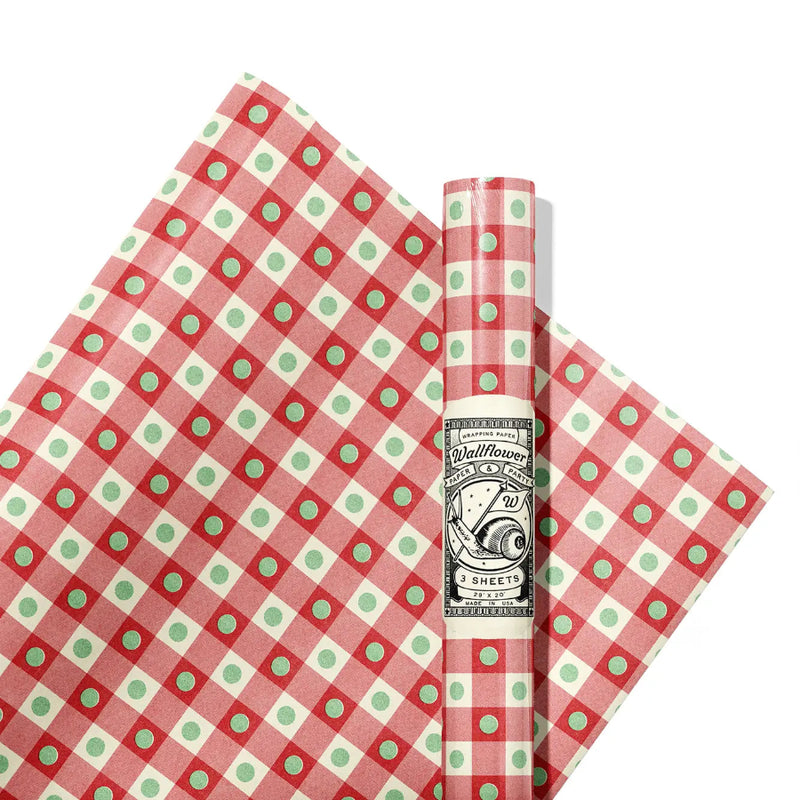 Red and green checkered paper with a roll of paper on a white background