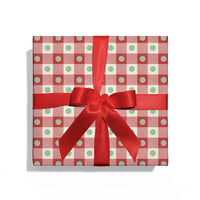 Gift box with red and white checkered pattern and a red ribbon on a white background