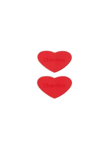 Two red, heart-shaped rubber grippers on a white background.