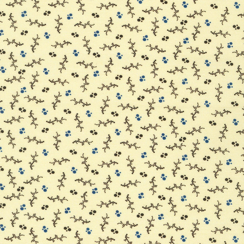 Patterned fabric with small black and blue designs on a beige background