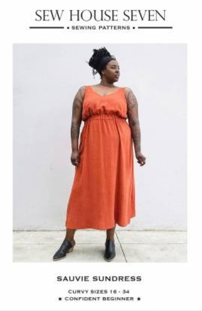 Sewing pattern cover for Sew House Seven's Sauvie Sundress, showing a woman modeling a sleeveless, gathered orange maxi dress against a plain light gray wall.