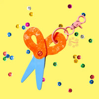 Scissors bag charm on a yellow background