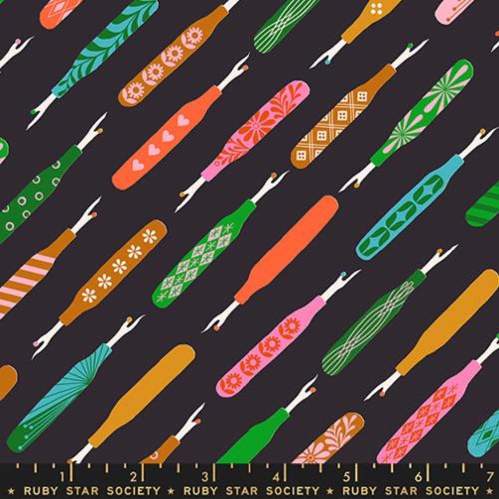 Colorful pattern of seam rippers with a ruler at the bottom on a black background with the  Ruby Star Society label.