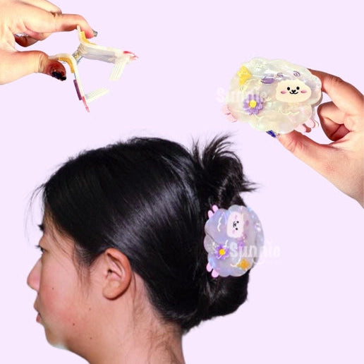 Person styling hair with a sheep hair clip against a white background