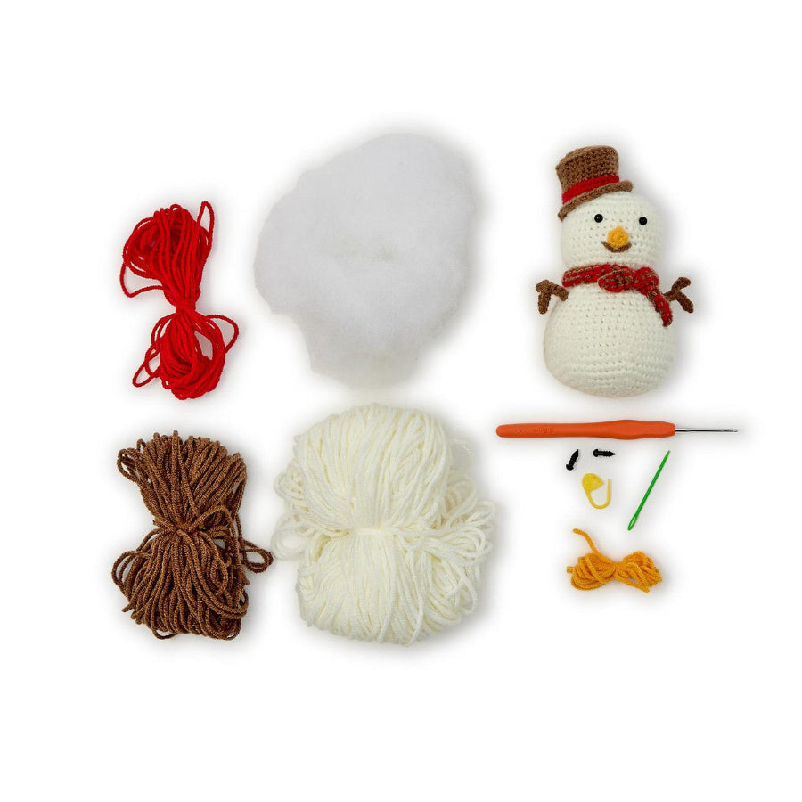 Crochet snowman kit with yarn, hook, and snowman figure on a white background