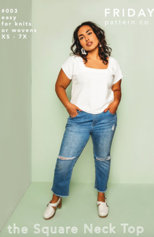 Model in white square neck top, jeans, and white block heels on a sage green background with Friday Pattern Co. branding and text.