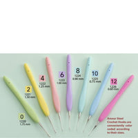 Set of colorful crochet hooks with size markings on a light green background
