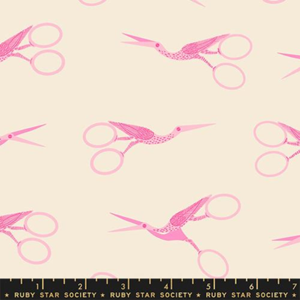 Fabric pattern with pink stork scissors and birds on a beige background. There is a black ruler on the bottom with the Ruby Star Society label.