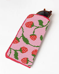 Needlepoint sunglasses case with a pink and red strawberry design on a white background
