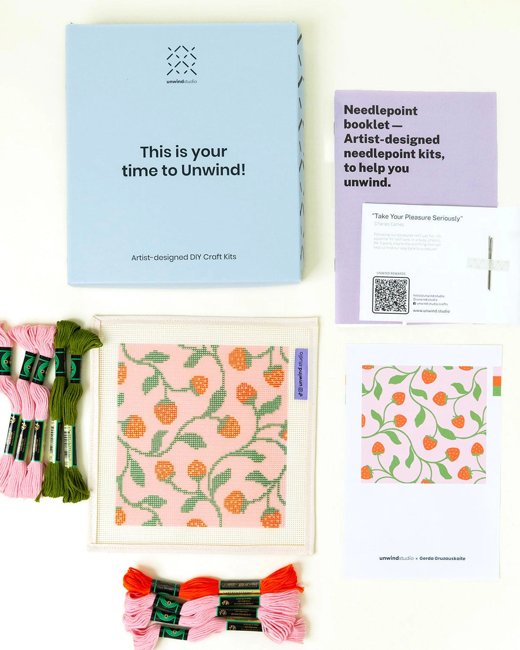 Needlepoint kit materials including canvas, thread, and instructions on a white background