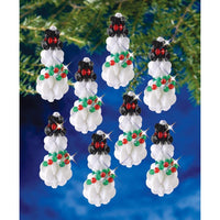 Decorative Christmas ornaments featuring black bears with red bows and green holly leaves on a blue background.