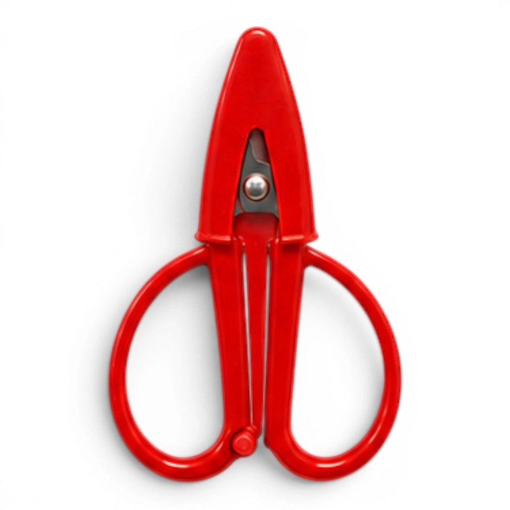 A small red pair of scissors with a matching point protector on a white background