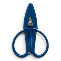 A small navy blue pair of scissors with a matching point protector on a white background