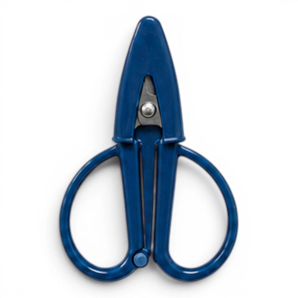 A small navy blue pair of scissors with a matching point protector on a white background