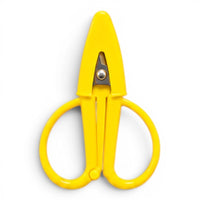 A small bright yellow pair of scissors with a matching point protector on a white background