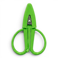 A small bright green pair of scissors with a matching point protector on a white background