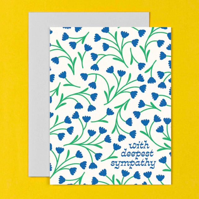 White card with blue flowers. 'With deepest sympathy'