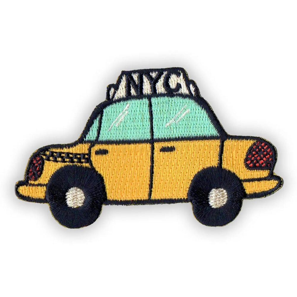 An iron-on patch of a yellow taxi cab design with NYC on the top, against a white background.