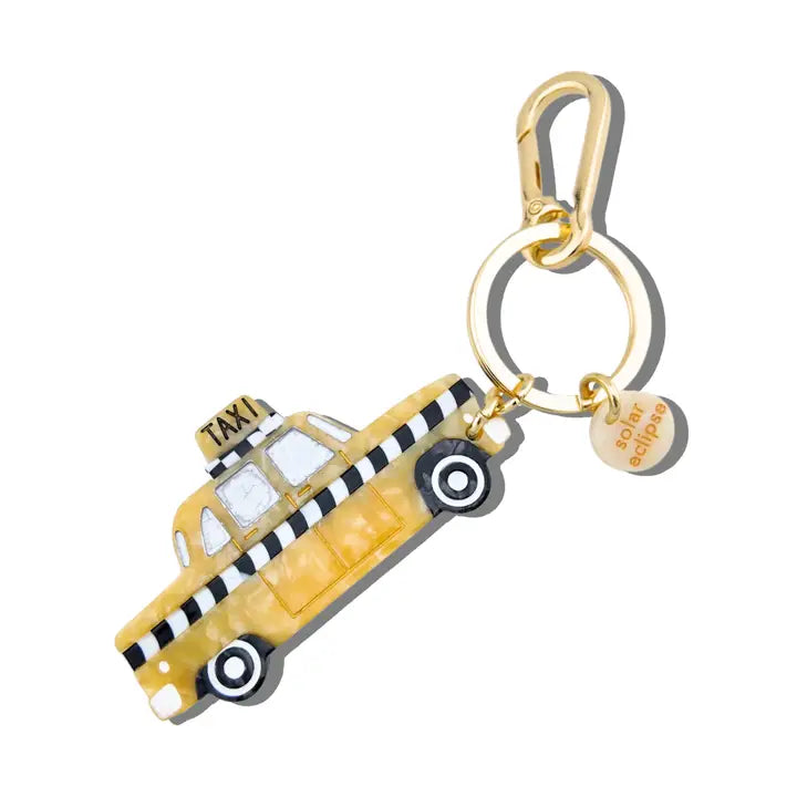 Keychain shaped like a yellow taxi cab with a gold carabiner on a white background