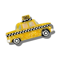 Hair claw clip shaped like a yellow taxi.