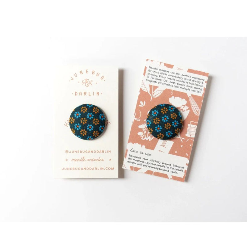 Floral patterned needle minder on branded cards with 'Junebug Darlin' branding.