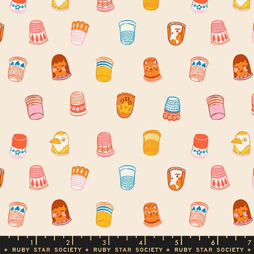 Patterned fabric with colorful thimbles a beige background, featuring Ruby Star Society label.