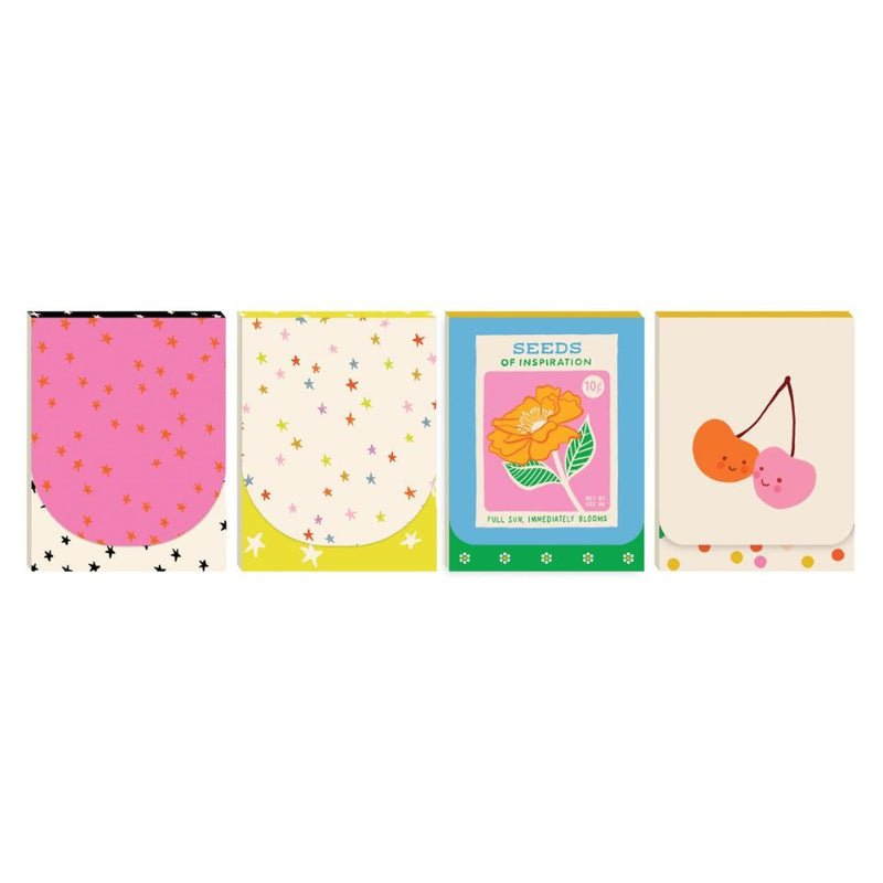 Four colorful notepads with different designs on a white background