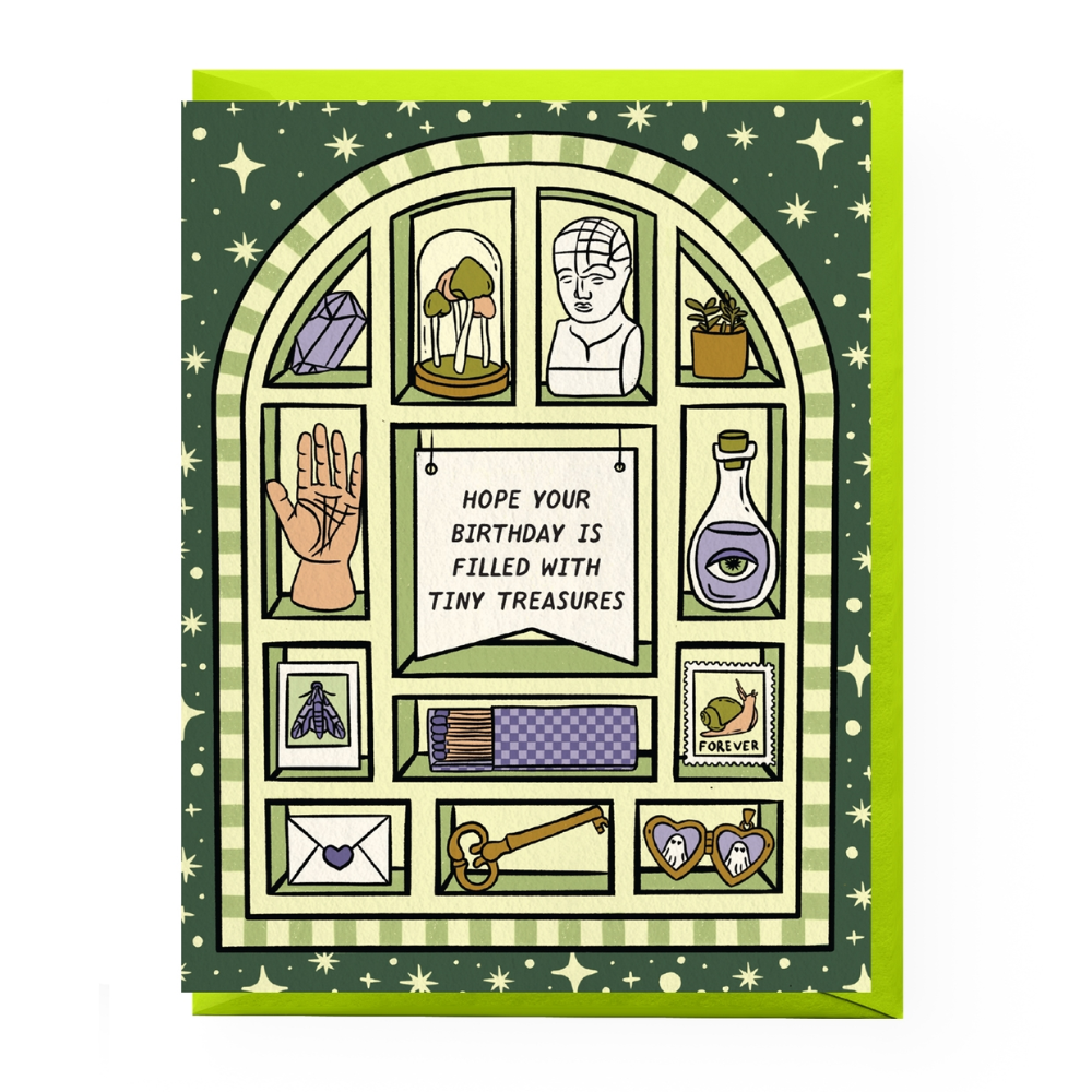 Green patterned card reads "Hope your birthday is filled with tiny treasures" and features an illustrated cabinet of curiosities filled with a locket, stamp, skeleton key, mushroom terrarium, and matchbook, with lime green envelope.