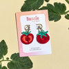 Tomato-shaped earrings on a 'Sunnie Creative' branded card with green leaves in the background.