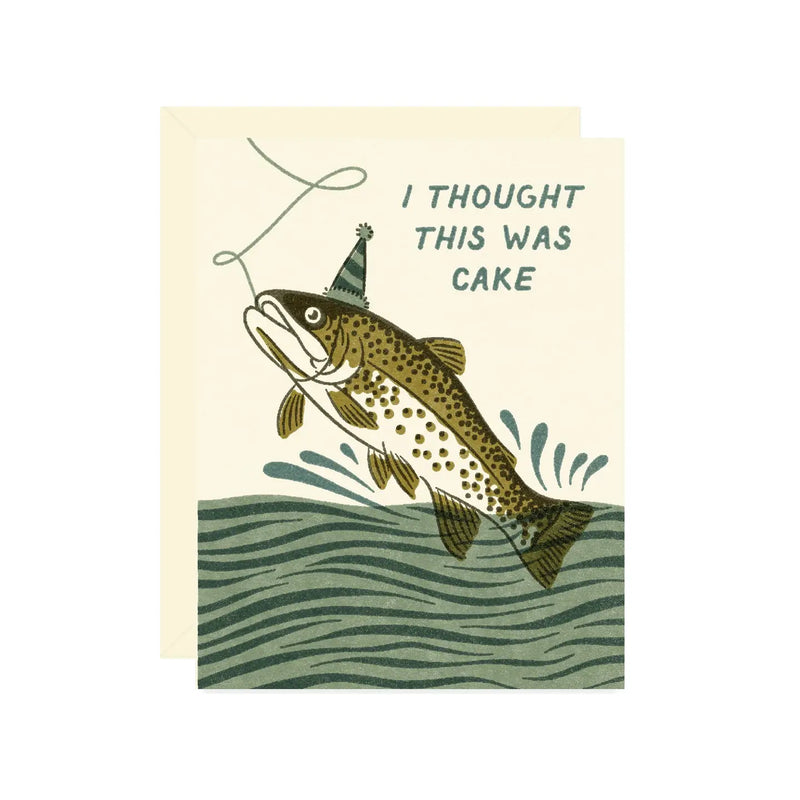 Beige card illustrated with a vintage inspired fish wearing a party hat leaping from the water and text reading “I Thought This Was Cake" on a white background.