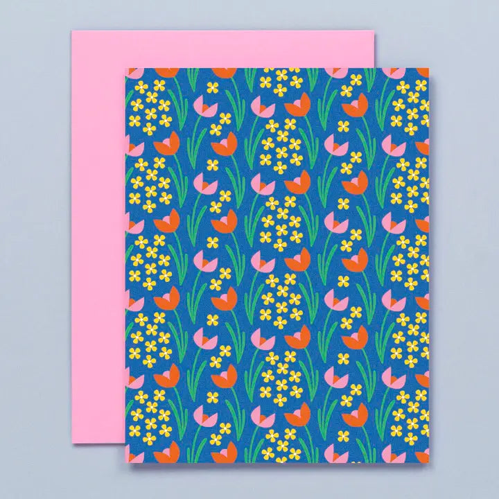 Floral patterned card with pink envelope on a light blue background