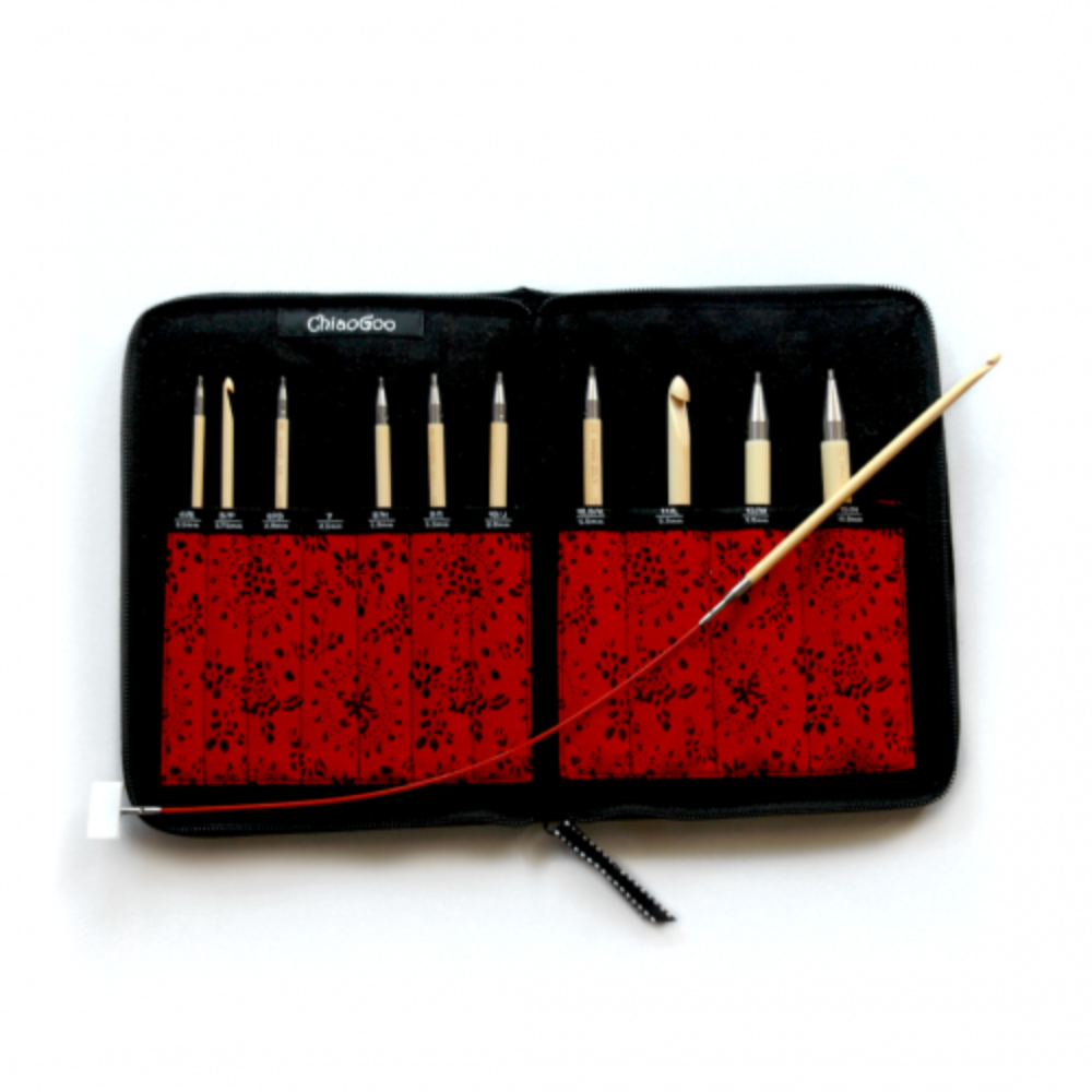 Set of tunesian crochet hooks in a black case with red interior on a white background