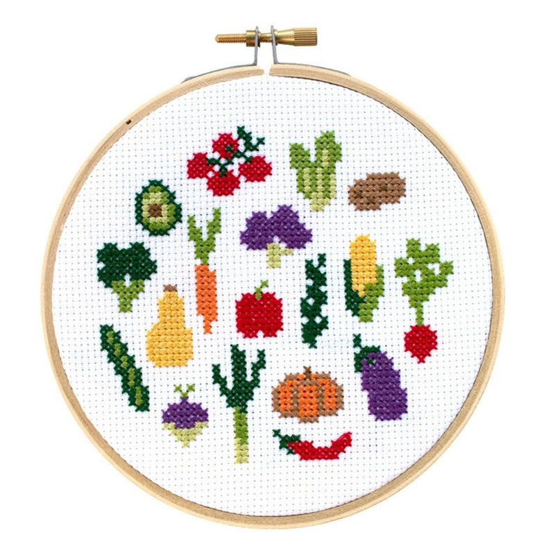 Cross-stitched vegetables in a wooden hoop on a white background