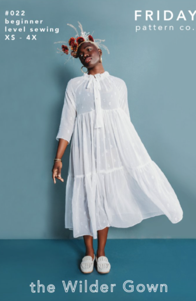 A model wearing a long white dress and a flower crown on a blue background with Friday Pattern Co. branding and text.