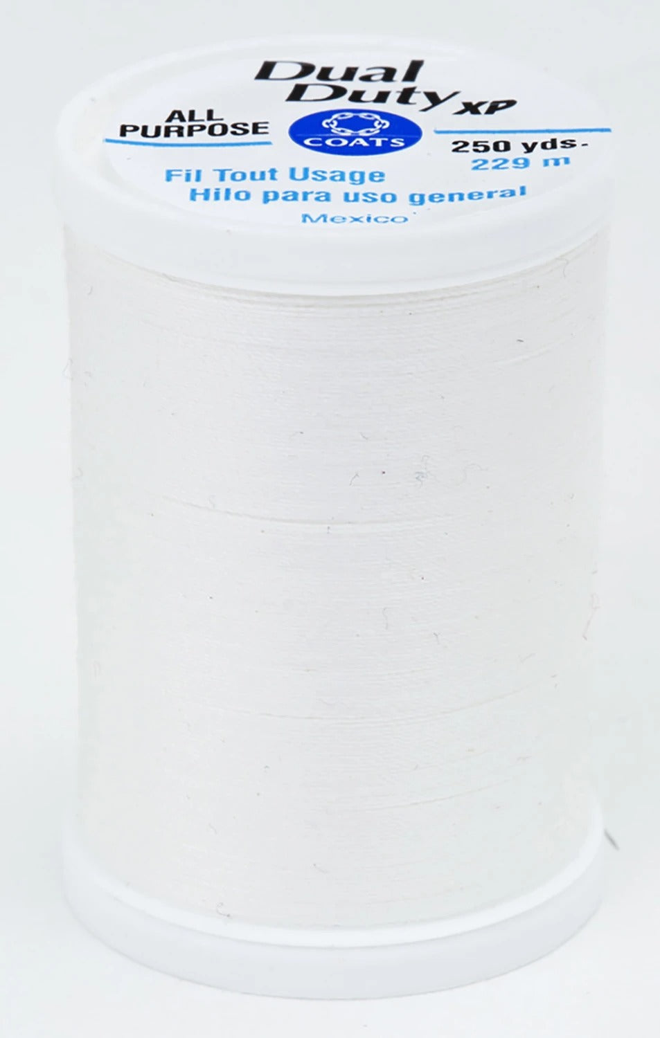 A spool of white Dual Duty XP sewing thread with a white label featuring blue and black text, set against a plain white background.