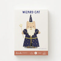 Front of a felt doll kit box labeled 'WIZARD CAT felt doll kit' with an illustration of a beige cat wearing a blue wizard robe and hat, on a white background.